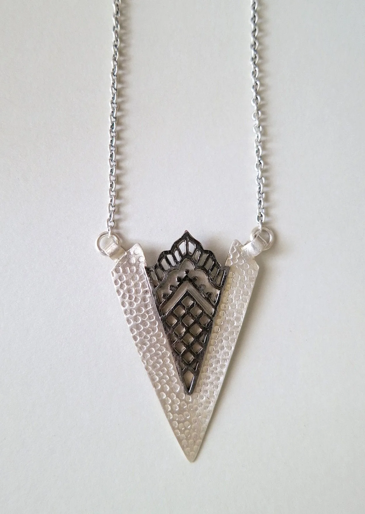 Artistic, arrowhead shape pendant necklace with black rhodium plated detailing