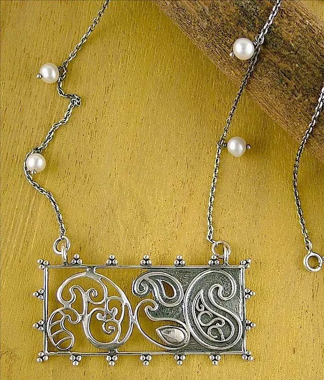 Artistic, rectangular paisley pendant on pearls interspersed chain