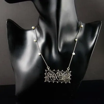 Artistic, rectangular paisley pendant on pearls interspersed chain