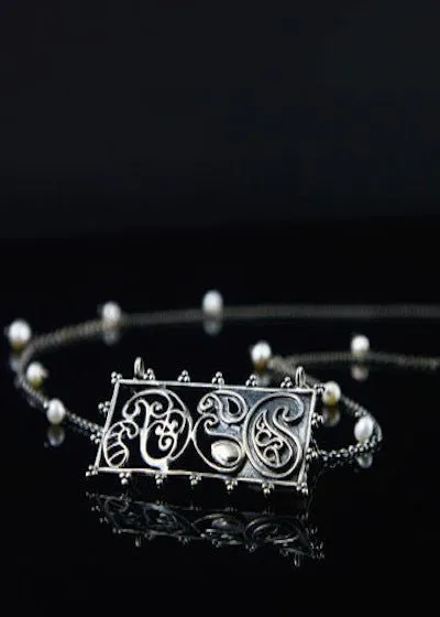 Artistic, rectangular paisley pendant on pearls interspersed chain