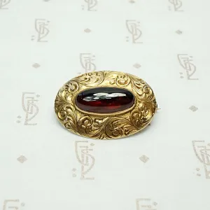 Garnet Cabochon Brooch in Engraved Gold