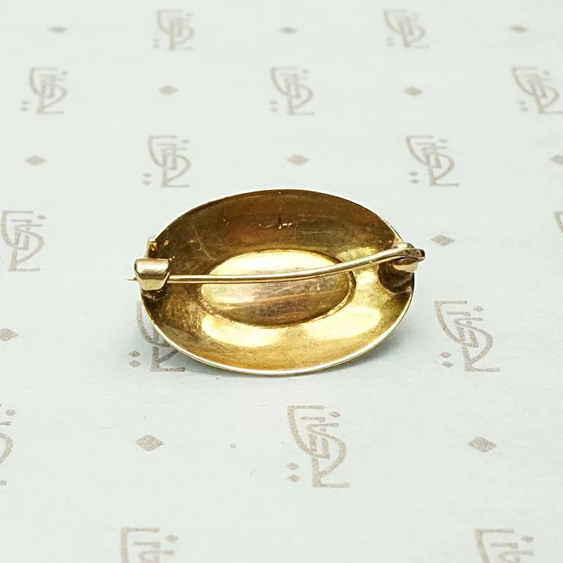 Garnet Cabochon Brooch in Engraved Gold