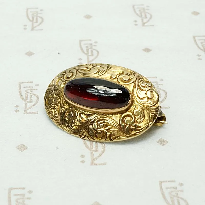 Garnet Cabochon Brooch in Engraved Gold
