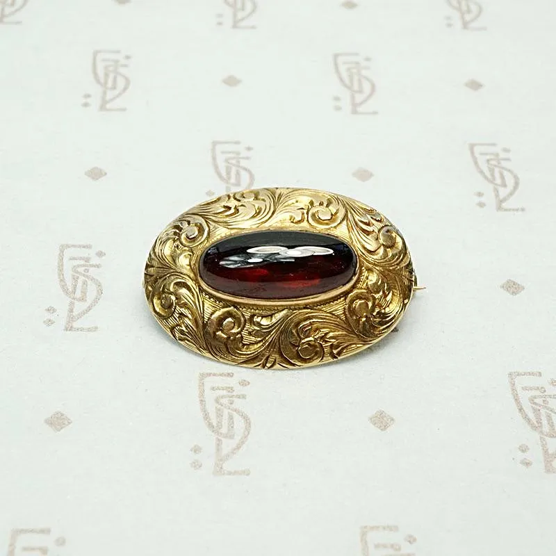 Garnet Cabochon Brooch in Engraved Gold